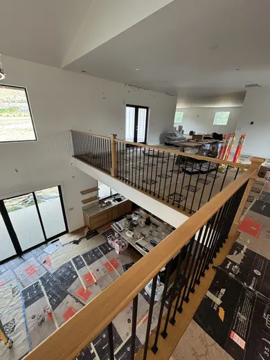 Wood treads, substantial newel posts, black balusters and warm step lighting, view 4.