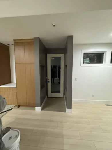 Slab wood cabinets, a gray island and a recessed wood-trimmed niche, view 10.
