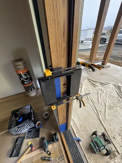 Wood entry door fitting and white lower-wall panel trim in the same entry, view 2.