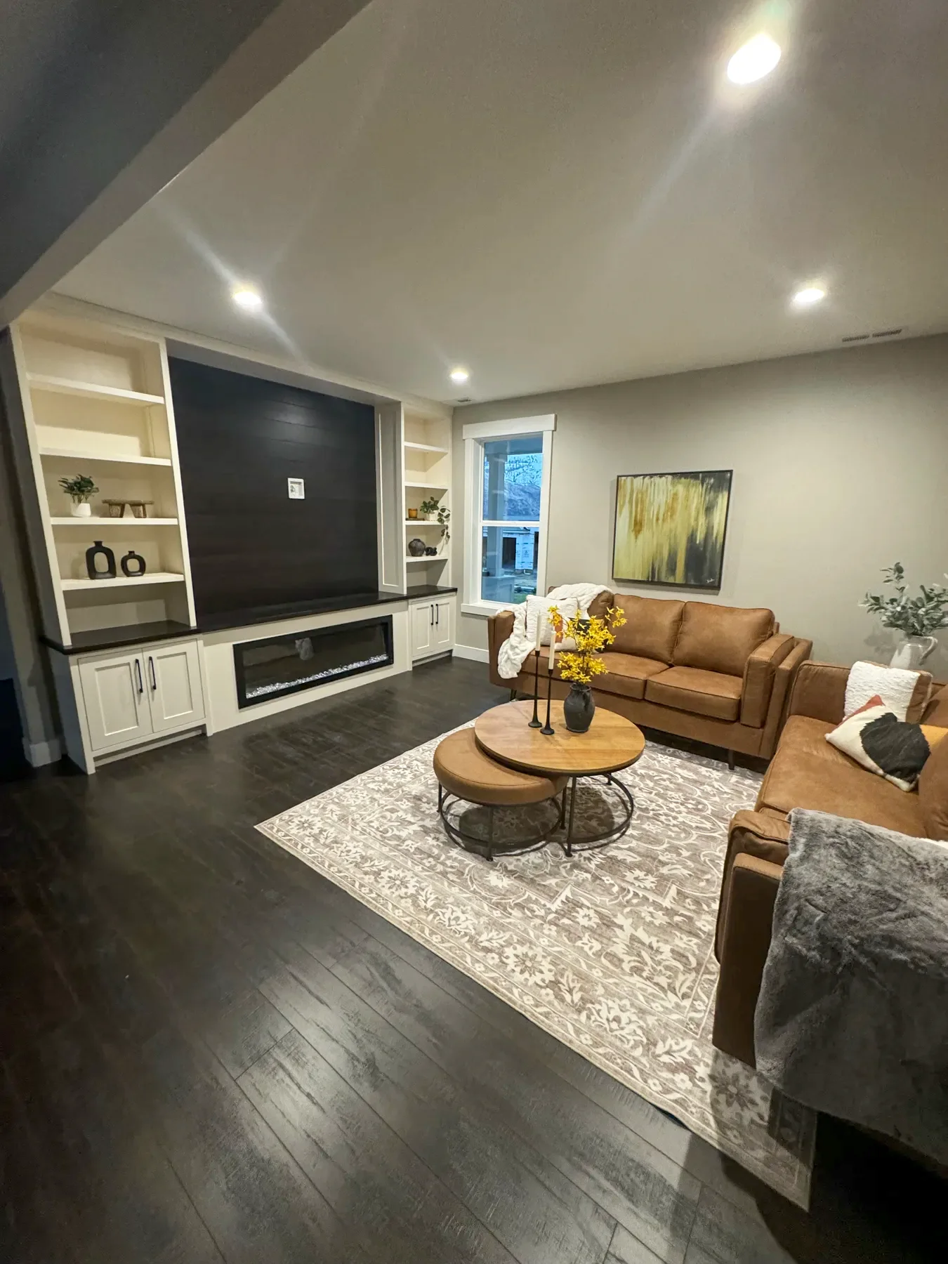 Finished white built-ins around a dark fireplace wall